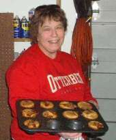 Ann Schroeder serving up hot cinnamon muffins
