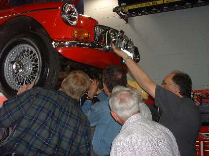 People under the nose of an MGB